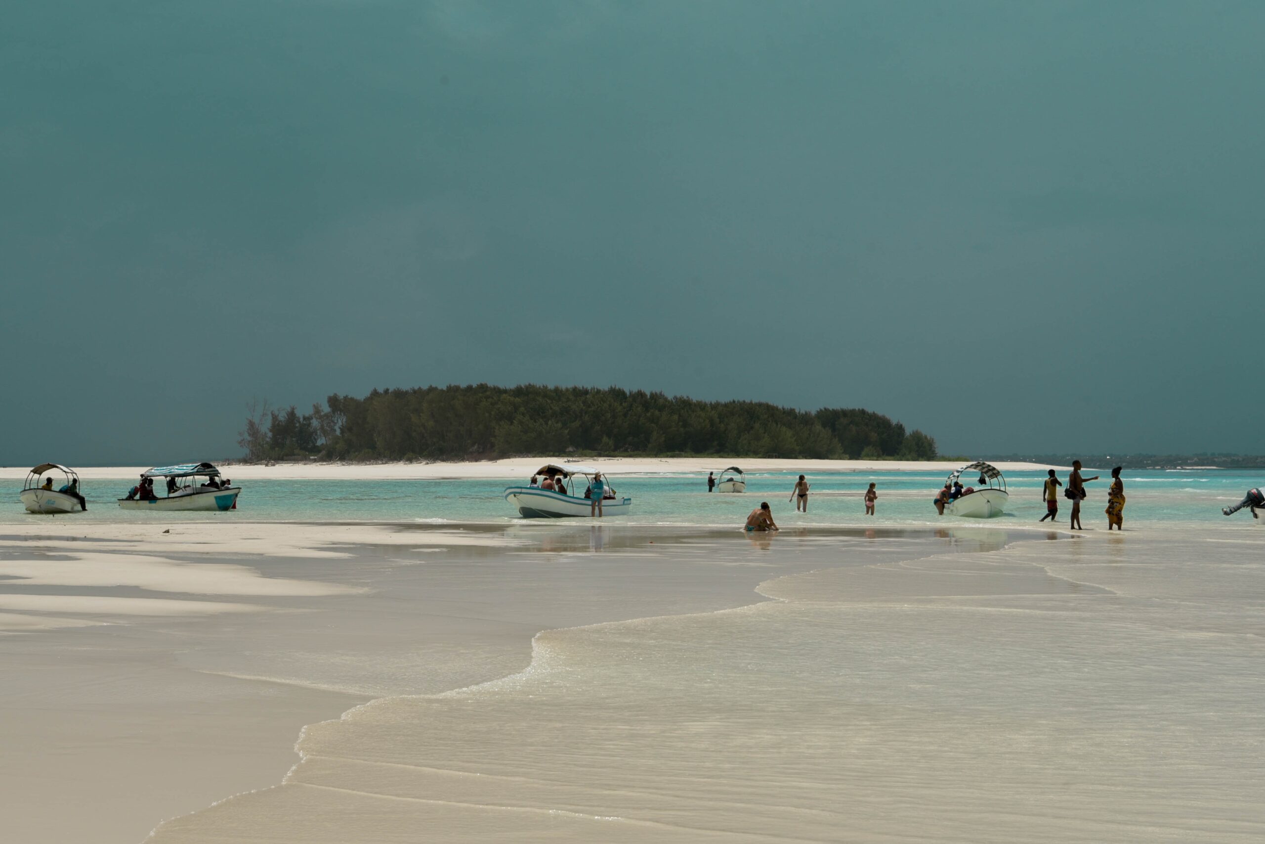 People driving boats in zanzibar island-Mado Tours Africa