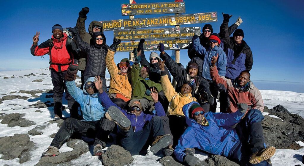Group of trekkers at Uhuru peak of Mount Kilimanjaro-Mado Tours Africa